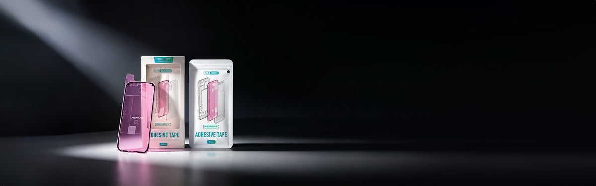 Two boxed iphone repair products standing on a dark surface under dramatic spotlighting. 